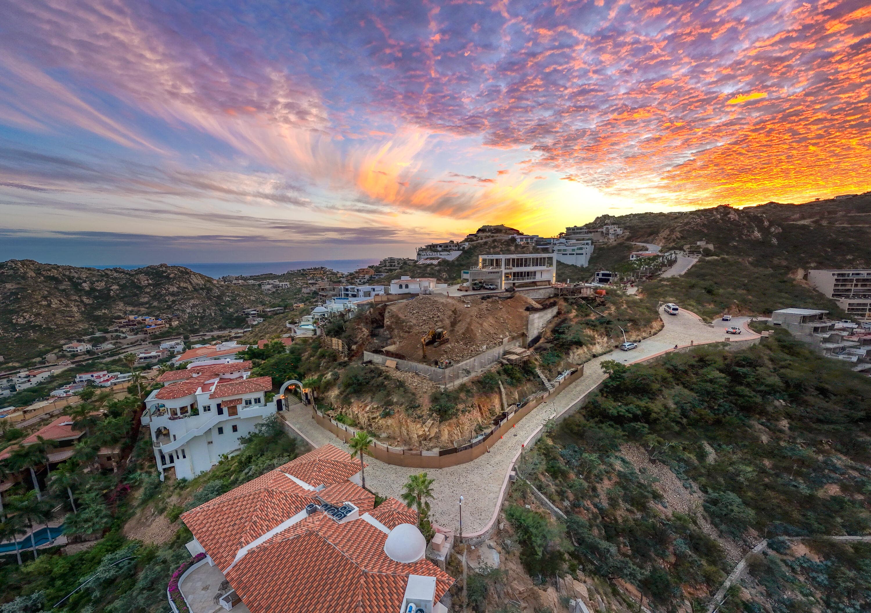 Aerial sunset over the excavated Villa del León lot in Pedregal, Cabo San Lucas
