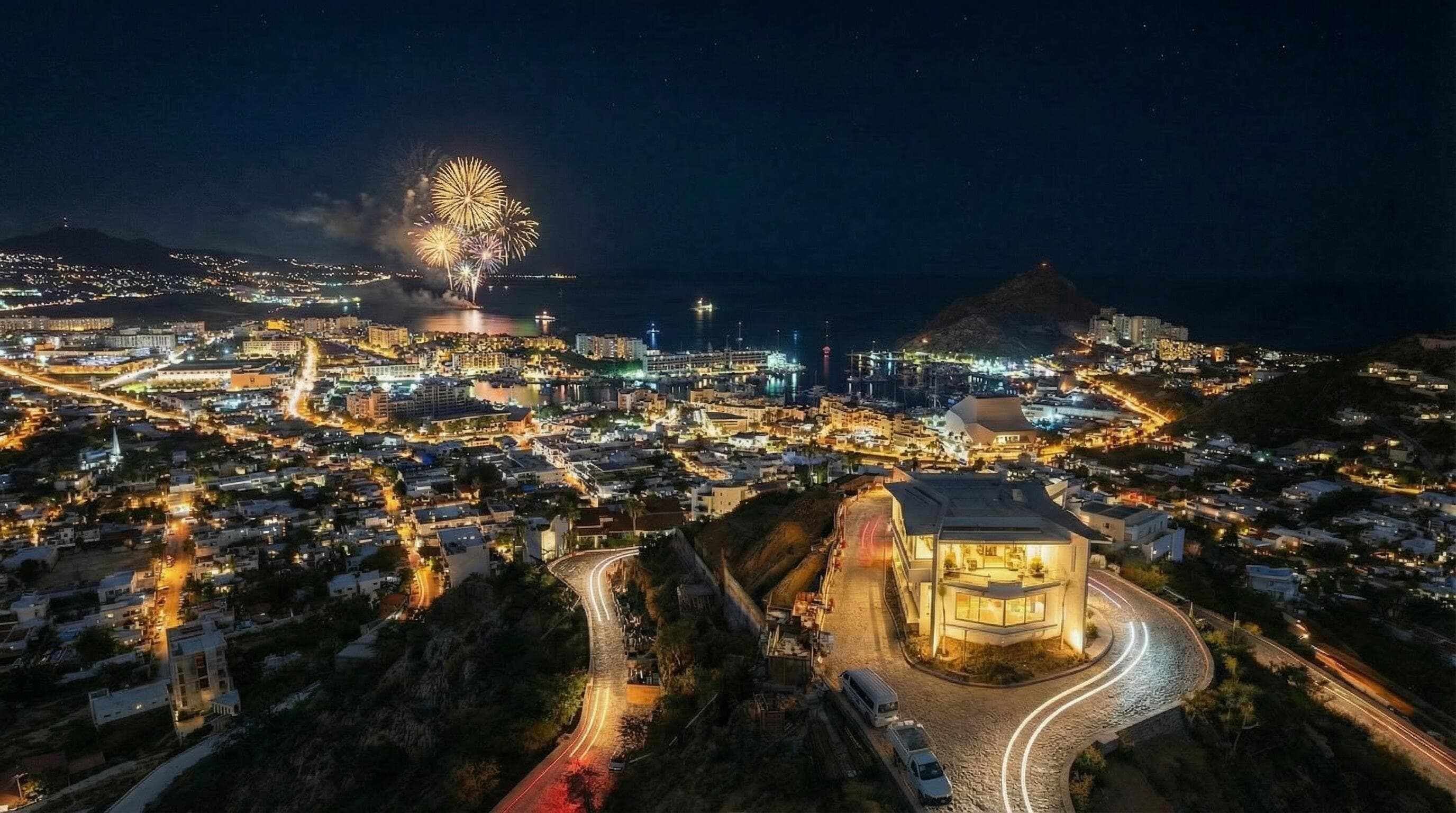 Night drone from the Pedregal ridge at Villa del León toward the Cabo marina and bay