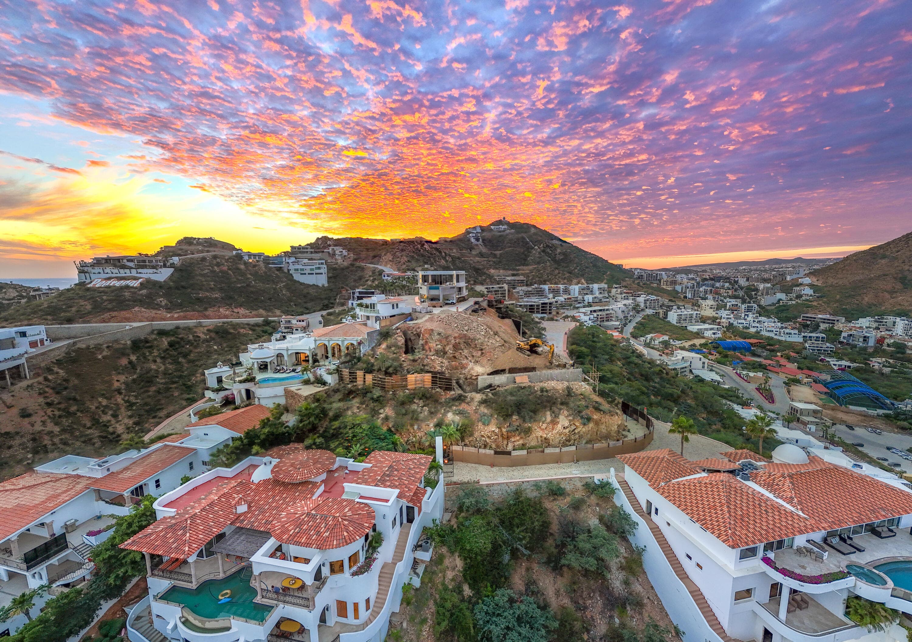 Sunset drone of Villa del León construction among Pedregal villas in Cabo