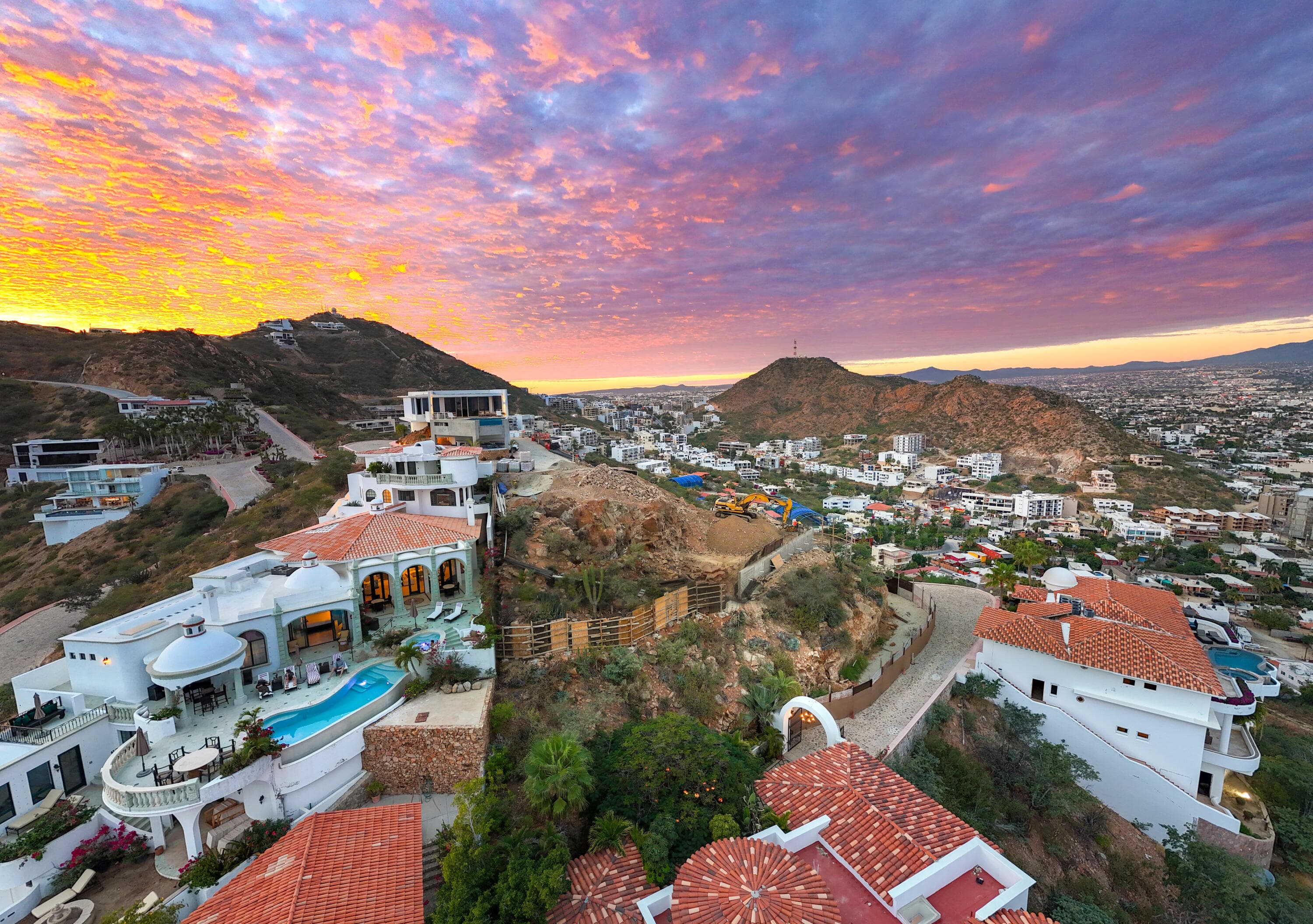Sunset over the Villa del León lot in Pedregal, with Cabo city lights beginning below