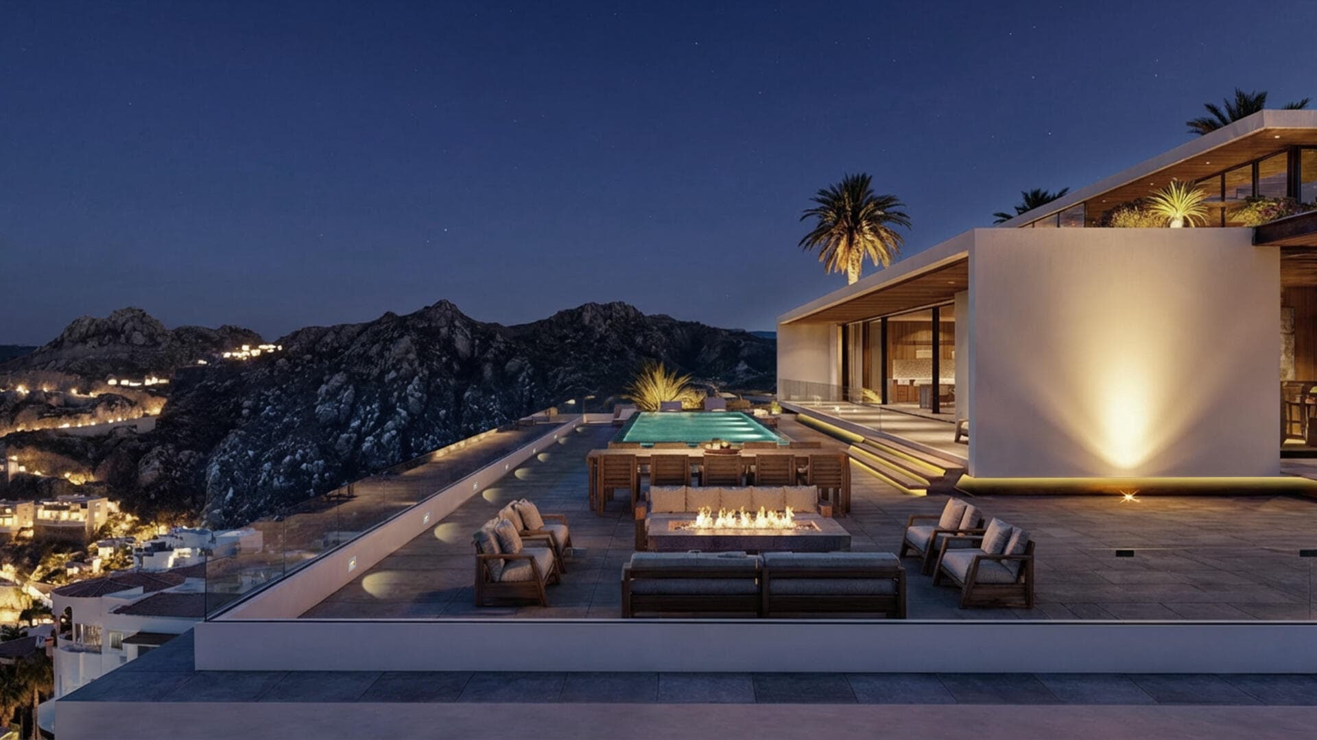 Villa del León night terrace in Pedregal, Cabo — fire pit, dining, and illuminated infinity pool