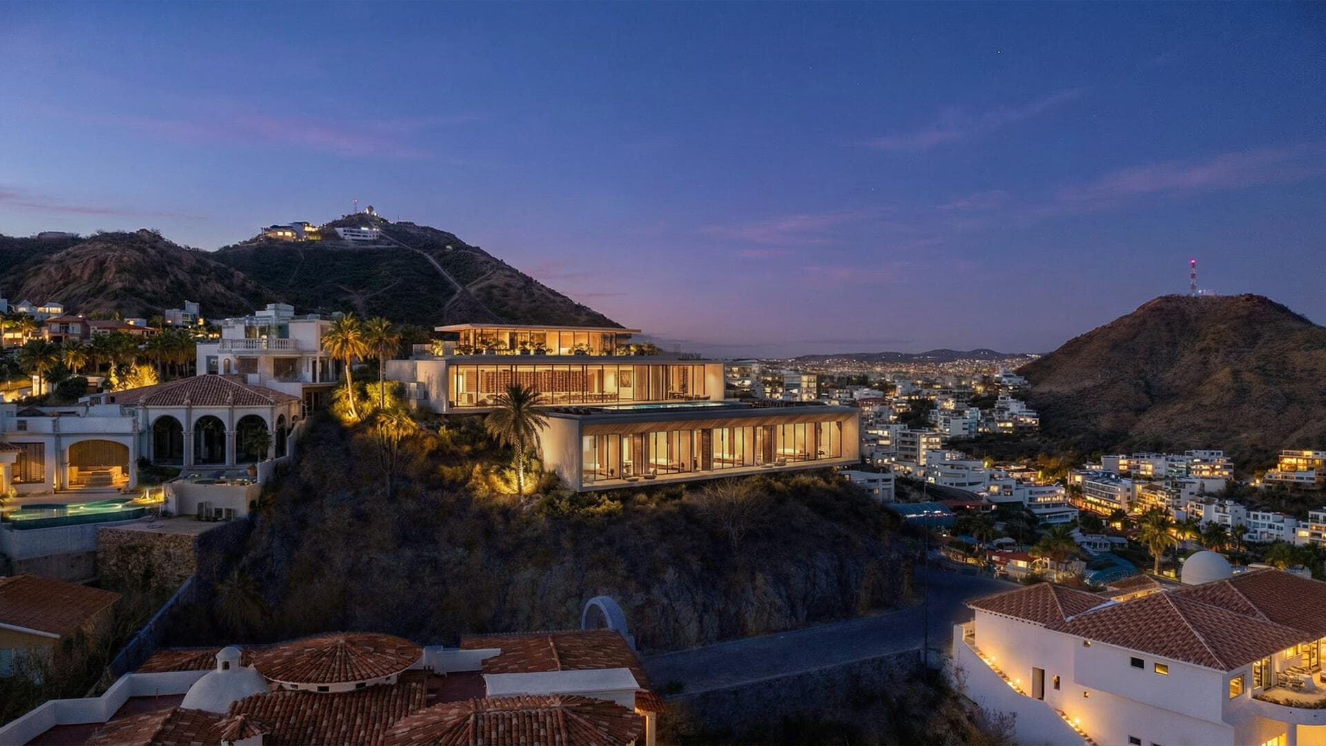 Villa del León at dusk on the Pedregal hillside, overlooking city lights